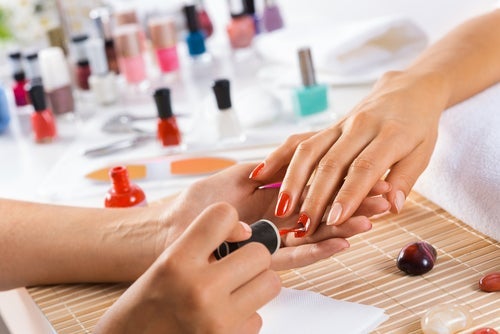 Woman in salon receiving manicure by nail beautician | Priority Hyundai in Chesapeake VA